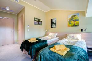 Posteľ alebo postele v izbe v ubytovaní Ratusz B&B