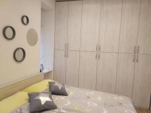 a bedroom with white cabinets and a bed at Studio apartment Arija in Zagreb
