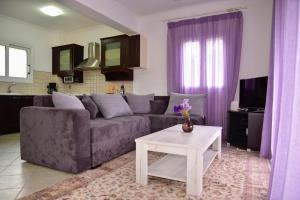 a living room with a couch and a table at Corfu Villa Levanta in Kontokali