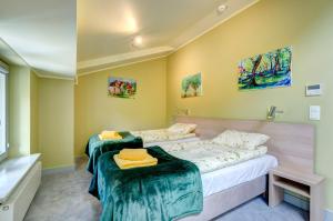 Posteľ alebo postele v izbe v ubytovaní Ratusz B&B