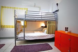 a bunk bed in a room with a bedroom at Navel Orange Hostel in Taitung City