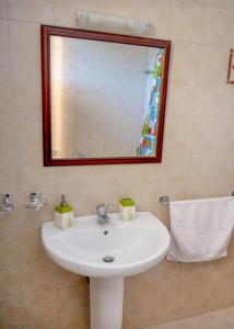 a bathroom with a white sink and a mirror at Kiotari Dreams in Kiotari