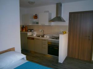 a small kitchen with a sink and a stove at Studio apartment Luzia in Komiža