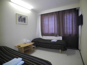 a hotel room with two beds and a window at Hotelli Anna Kern in Imatra +47 photos