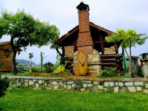 drewniany domek z ceglanym kominem i kamienną ścianą w obiekcie Holiday Homes Fairy Tale w mieście Varaždin