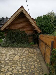 a house with a fence and a stone patio at Holiday Homes Fairy Tale in Varaždin