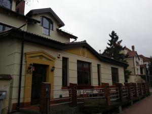 a house with a fence in front of it at Willa Kalinowa in Sopot
