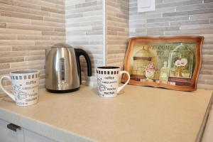 a counter with three coffee mugs and a kettle at DreamHouse 1 - Komotini in Komotini