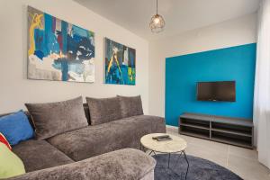 a living room with a couch and a tv at Astinian apartments Jadranka in Pula