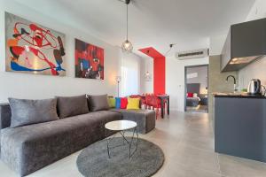 a living room with a couch and a table at Astinian apartments Jadranka in Pula