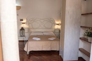 En eller flere senge i et værelse på Centro Casa Monteleone