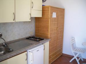 a small kitchen with a sink and a stove at L'Isolana Case Vacanza Luna 1 in Ponza