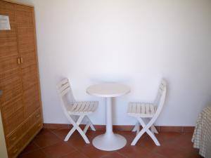 two chairs and a table in a room at L'Isolana Case Vacanza Luna 1 in Ponza +4 photos