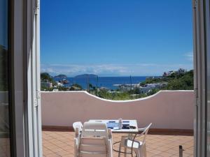 a table and chairs on a balcony with a view of the ocean at L'Isolana Case Vacanza Luna 1 in Ponza