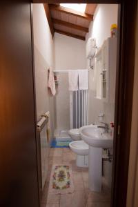 a bathroom with a toilet and a sink at Appartamenti Massarella in Fucecchio