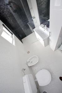 a white bathroom with a toilet and a sink at Vito in Bibinje +25 photos
