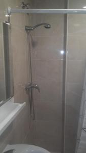 a shower with a glass door in a bathroom at Hospederia Gomis 26 in Ontinyent