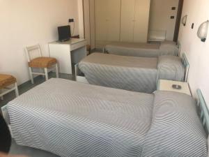 Postel nebo postele na pokoji v ubytování Hotel Cristallo