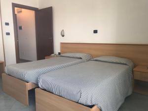 Postel nebo postele na pokoji v ubytování Hotel Cristallo