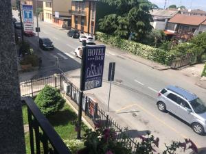 una vista de una calle con un cartel de hotel y un coche en Hotel Cristallo, en Novara