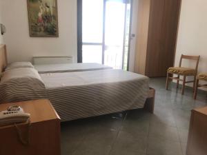 Postel nebo postele na pokoji v ubytování Hotel Cristallo