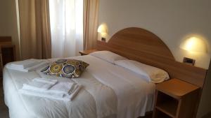 Postel nebo postele na pokoji v ubytování Hotel Milano