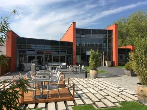 a building with tables and chairs in front of it at cantera by Wiegand in Wunstorf