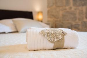 Una toalla con un pájaro sentado en una cama en Fairy Of The Seas Apartments, en Split