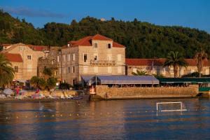 a building next to a body of water at Hotel Glavovic in Lopud Island
