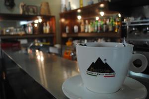 a coffee cup sitting on a counter at a bar at Hotel South Paradise in Palmi
