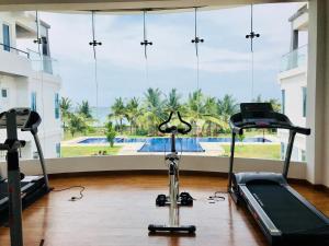 a gym with a exercise bike and a large window at Araliya OceanFront Condos Nilaveli, Trincomalee in Nilaveli