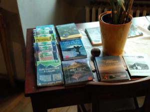 a table with a bunch of books on top of it at Porta Rose in Garessio