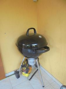 a grill sitting on a stand in a room at Forrás-G Vendégház in Bük