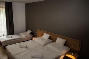 Ένα ή περισσότερα κρεβάτια σε δωμάτιο στο Hotel Mátrix