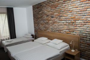 Ένα ή περισσότερα κρεβάτια σε δωμάτιο στο Hotel Mátrix