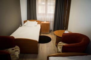 Ένα ή περισσότερα κρεβάτια σε δωμάτιο στο Hotel Mátrix