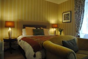 a bedroom with a large bed and a couch at Killiane Castle Country House & Farm in Wexford