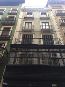 a tall building with windows and balconies on it at Atico Estafeta in Pamplona