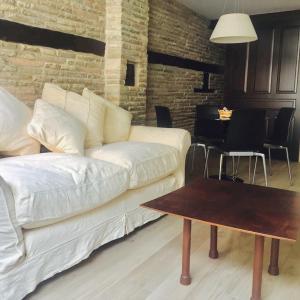 a living room with a white couch and a table at Atico Estafeta in Pamplona