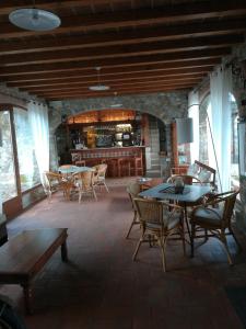 een woonkamer met tafels en stoelen en een keuken bij Giunasco in Bagnone
