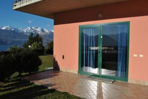 a door to a house with a view of the mountains at Residence Oasi Del Viandante in Dervio
