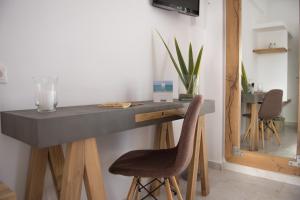 a desk with two chairs in a room at The Wave in Sidari