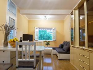 a kitchen and living room with a table and a couch at Apartmani Mlinar in Gornji Karin