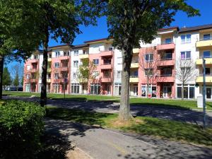 an apartment building in a park with trees at Hanna Apartman in Bük