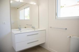a white bathroom with a sink and a mirror at Albipavillon in Albi +15 photos