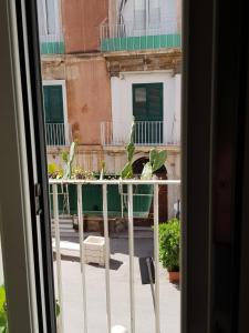 a view from a window of a balcony with plants at Buonanotte Margherita in Taranto