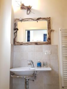 a bathroom with a sink and a mirror at Buonanotte Margherita in Taranto