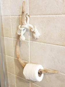 a roll of toilet paper hanging on a wall at Buonanotte Margherita in Taranto