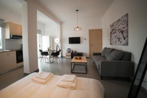a living room with a couch and a table at MCPlaces Holiday Apartments in Paphos