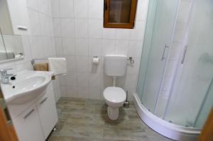 a bathroom with a toilet and a sink and a shower at Slanica studio ID 816 by HeartofDalmatia in Murter